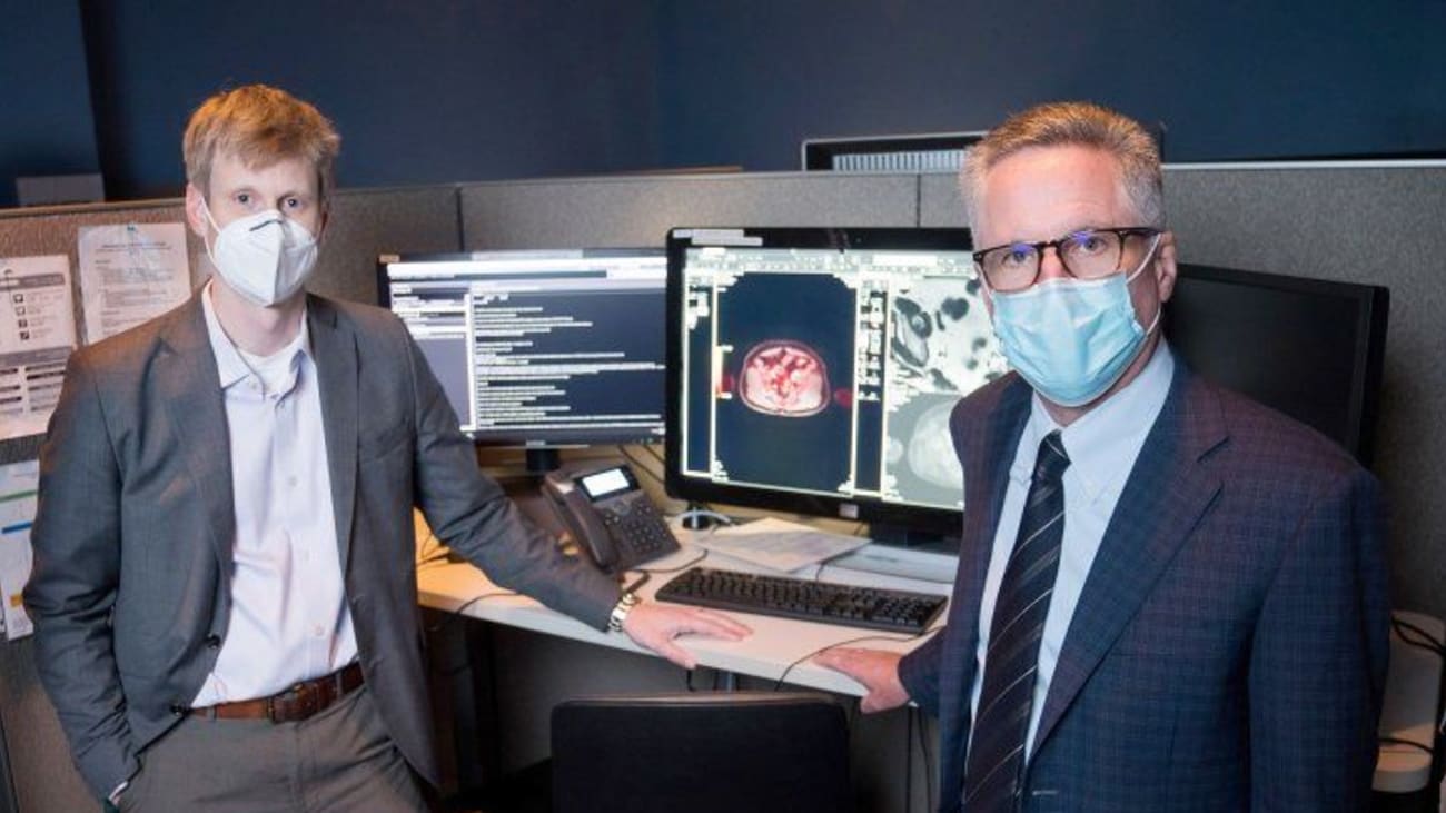 Thomas Hope (left), MD, and Peter Carroll, MD, stand at the PACS workstation where the images from the PSMA PETs are viewed and interpreted. The imaging technique received FDA approval in 2020. Photo by Maurice Ramirez