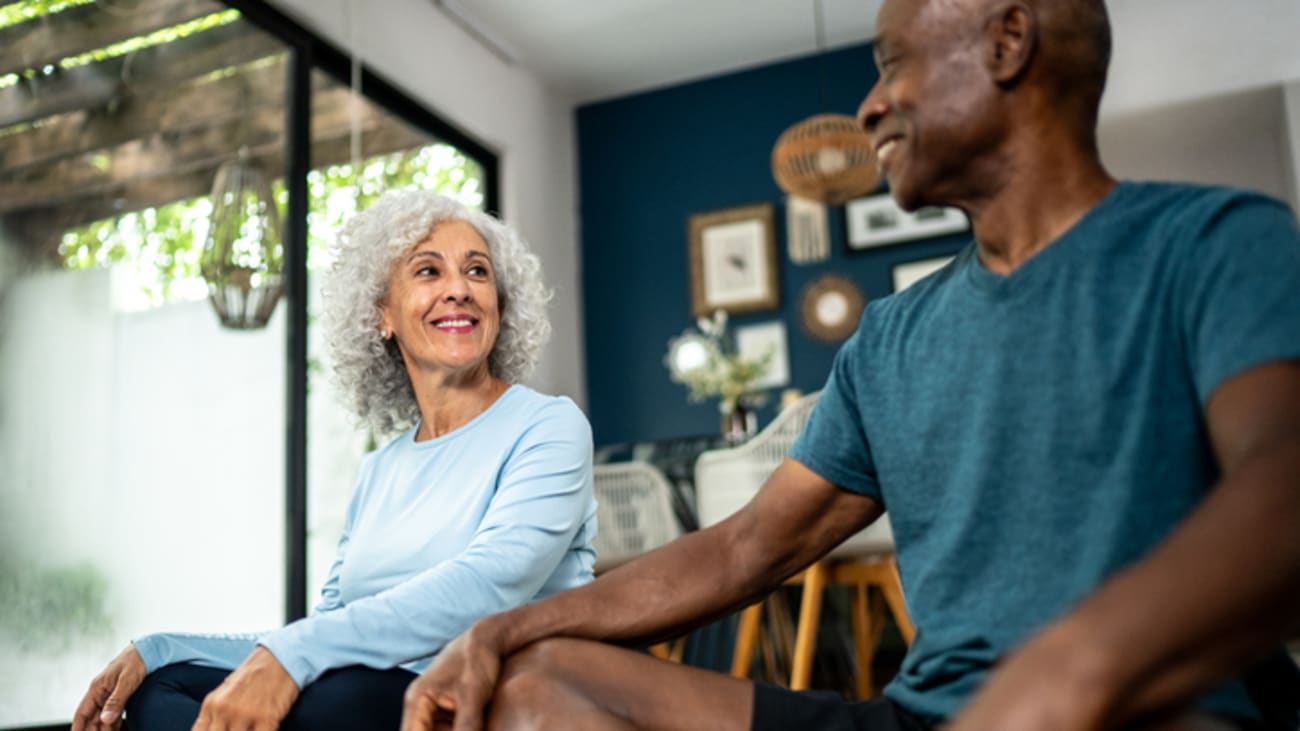stock image of an older couple doing yoga and smiling