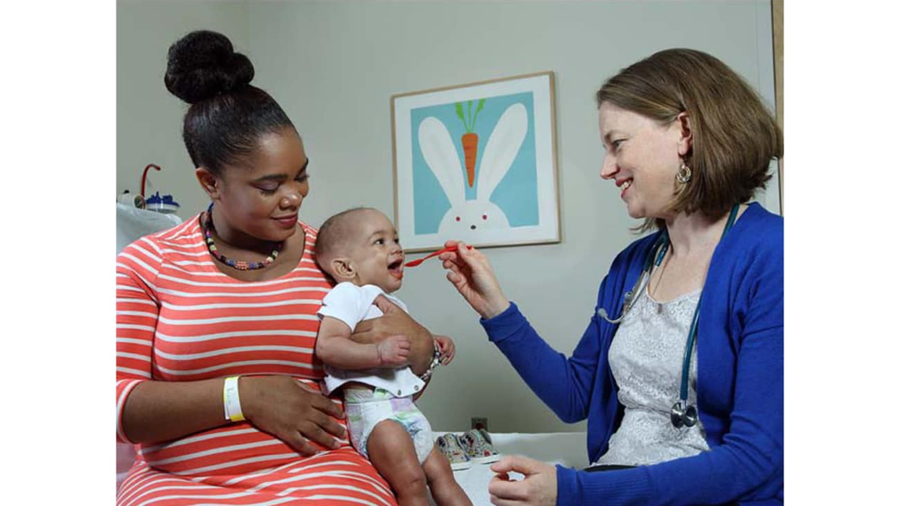 Pediatric allergist Corinne Keet with a young patient and mom in her early introduction to peanut trial.