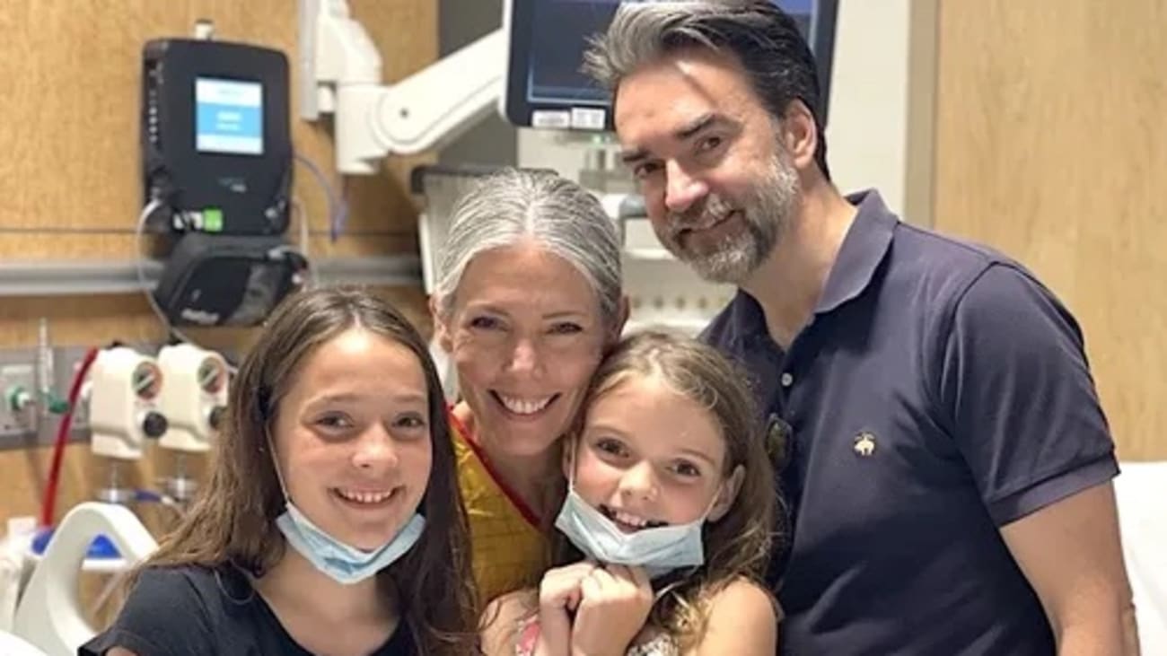 Laurie Enright and her family – husband Dan and daughters Frances, left, and Eleanor – were relieved to learn her ruptured aneurysm had stopped filling temporarily, but there were still a lot of unknowns.