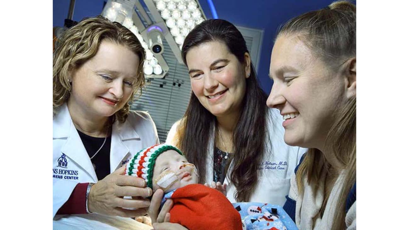 Christofer in the hands of PICU specialists, from left, Jamie Schwartz and Kristen Nelson, along with his mom, Joyce Ter Bush.