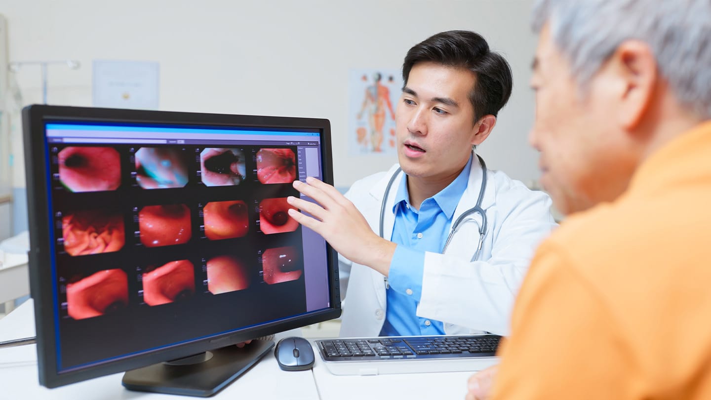 Clinician discussing endoscopy images with a patient.