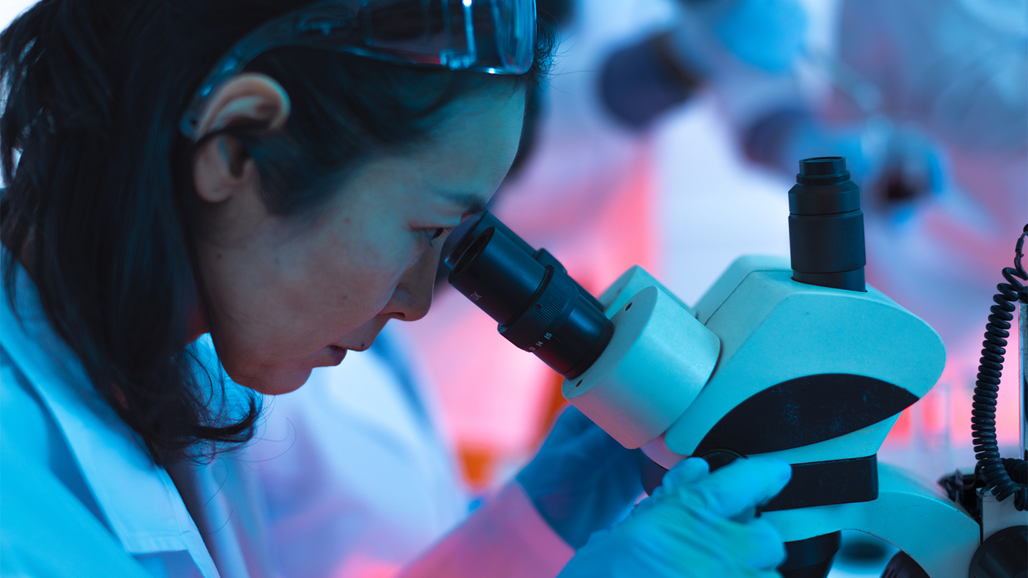 Researcher using a laboratory microscope.