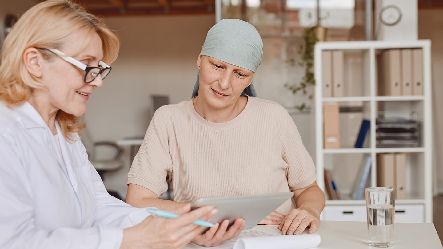 Clinician reviewing information with a patient during treatment.