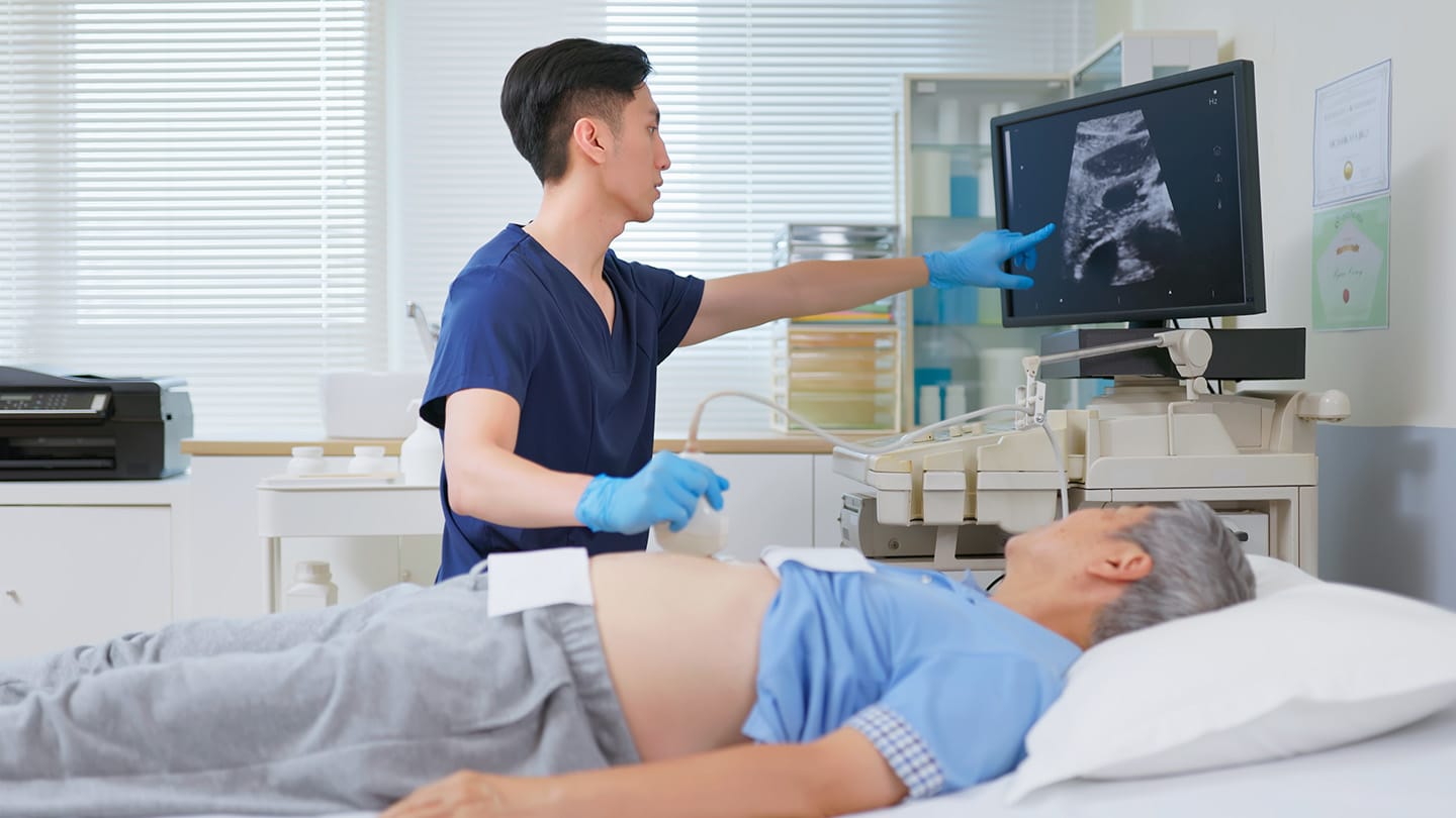 Clinician performing an abdominal ultrasound.