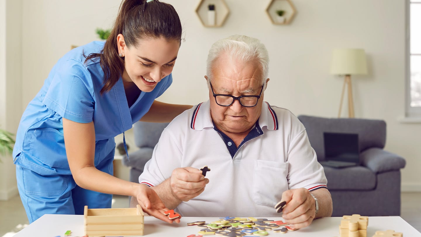 Caregiver assisting an older adult at home.