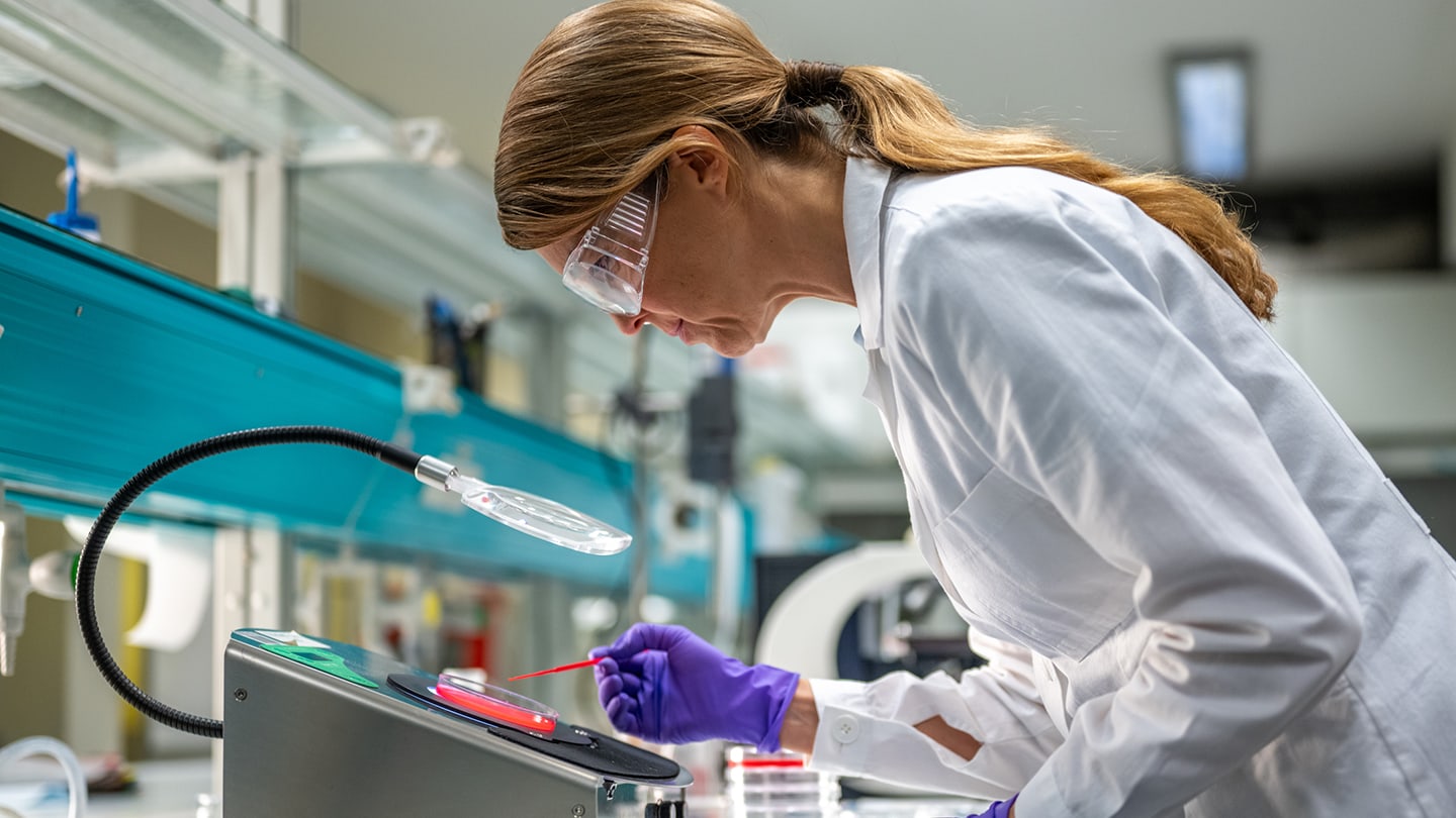 Researcher working with laboratory equipment.