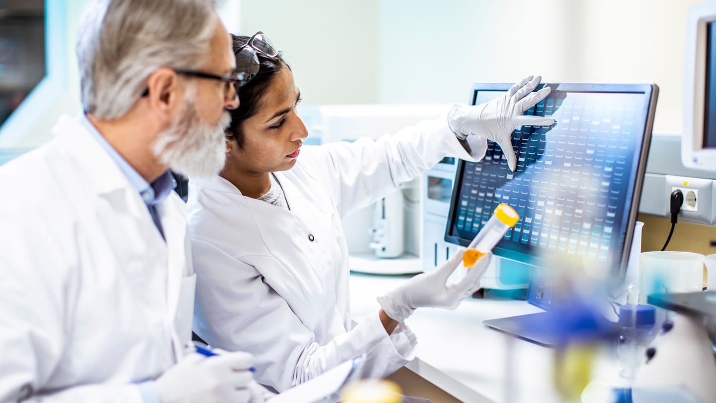 Researchers reviewing laboratory samples and data.