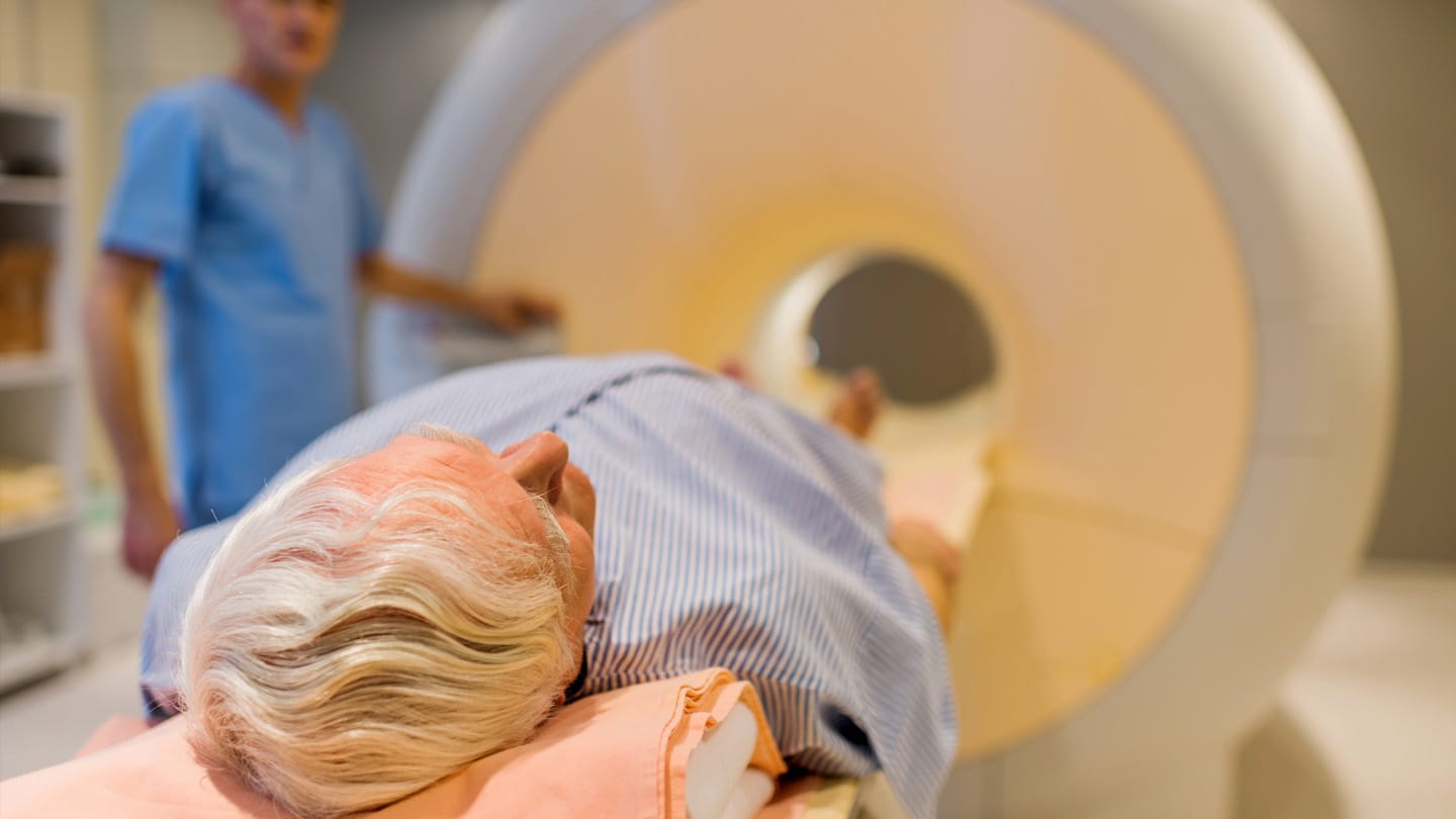 Patient undergoing medical imaging on a scanner table.