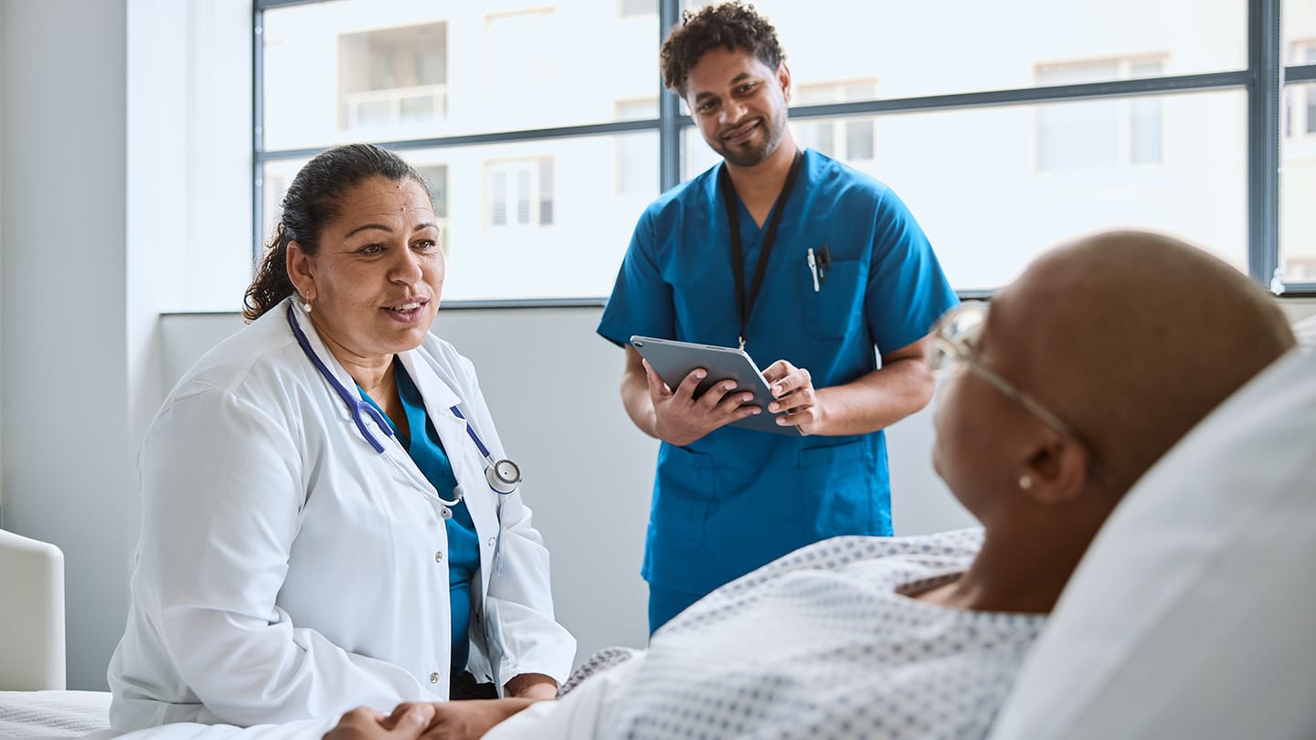 Clinical care team speaking with a patient.