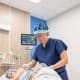 Nicole McCoy, M.D., uses a needle to perform a QL block on her patient prior to bone marrow harvesting. Credit: Brennan Wesley