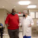 Dr. Lattouf talks with a patient as they walk down the hallway.