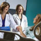 Amanda Fader, left, and Rebecca Stone, center, have helped make the Johns Hopkins minimally invasive surgery rate for hysterectomies performed for endometrial cancer and for women at risk of developing a gynecologic cancer among the highest in the nation.