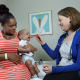 Pediatric allergist Corinne Keet with a young patient and mom in her early introduction to peanut trial.