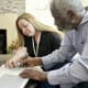 A home caregiver helps a man working on memory puzzles. According to Alzheimer’s Disease International, more than 55 million people worldwide – including nearly 7 million in the U.S. – are living with Alzheimer’s or other dementias. (Photo credit: Getty Images)