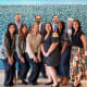 team of doctors posing together in front of blue tiled wall
