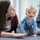 Craniofacial surgery patient, Rhoen Papini, with mom, Amber Schayltz, getting fitted for a new helmet as part of his post-operative care.