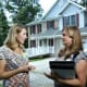 Quincy Samus, left, reviews a patient’s care plan with memory care coordinator Kelly Marshall outside a client’s home.