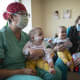 Abigail and Micaela Bachinskiy sit with nurses Aida Benitez and Dawn Harbour prior to their discharge from the UC Davis Children’s Hospital.