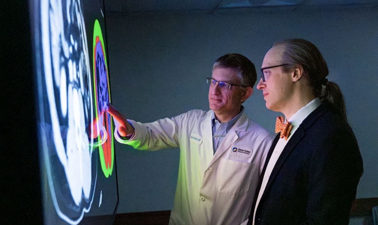 Brian Wolpin, MD, MPH (left), and Michael Rosenthal, MD, PhD, review CT scans that were analyzed by AI.