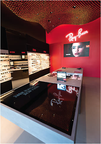 A high-tech communal table serves as the focal point of the new Ray-Ban store in LA.