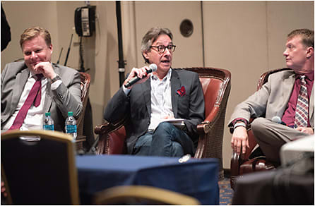 Edward Beiner, center, makes a point during the Retail Strategies Panel