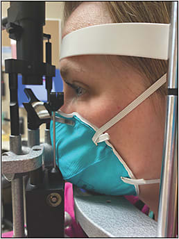 Figure 2. 3M Health Care Particulate Respirator and Surgical Mask positioned at the slit lamp.