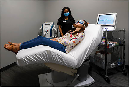 Sheena Thomas, CPO, ophthalmic technician, checks in a patient who is relaxing just prior to an IPL treatment. As part of the safety protocols implemented by the practice to address COVID-19: When the patient must unmask, due to the mask interfering with treatment, the patient is asked not to speak or open their mouth during the procedure.