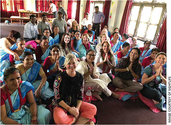 Female community health workers and SightLife Advocates have a seat in anticipation for the start of medical refresher training.