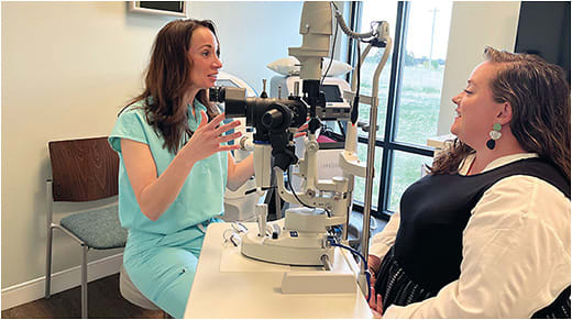 Dr. McGee discusses a diagnostic device with a staff member. Photo courtesy of Dr. McGee.