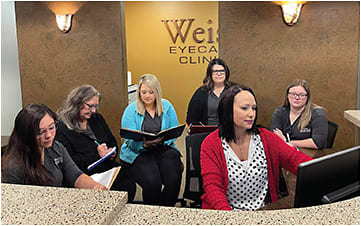 Dr. Weiss and her team going over the practice’s numbers at a Wednesday meeting. Photo courtesy of Dr. Weiss.