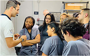 Jacopo Umattino (left), Thema’s production manager, working with Miami Dade students.
