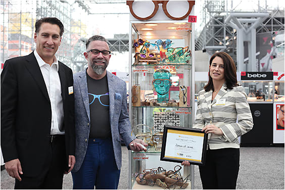 The Vision Council's Mitch Barkley and Melissa Ashley of Reed Exhibitions flank Vision Choice Award winner Ian Rubinstein of Specs of Wood. Other winners were Lunette USA Inc., and Marcolin