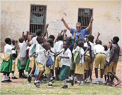 Moes Nasser, O.D., with students near his former school in Tanzania.