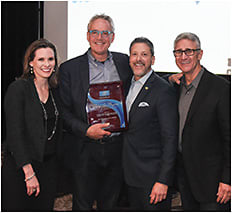 Steve Shawler receives the coveted Mary Lou Maguire Award. With him are (l-r) Kim Schuy, Howard Purcell, and Bob Colucci. During NSM, a fond farewell was also bid to Colucci (most recently president of Essilor IDD and chairman of the board at Essilor Vision Foundation), who recently retired after 28 years with Essilor.