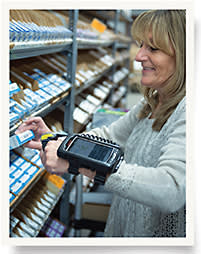 Shipping supervisor Gail Kimball shows off Global Optics’ state-of-the-art picking technology