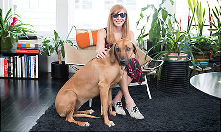 Celebrated fashion designer Nicole Miller, who produces an eyewear collection with L'Amy America, at home with her pooch