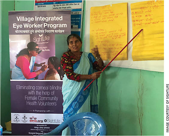 A community health worker presents discussion points for a lesson for a training breakout session.