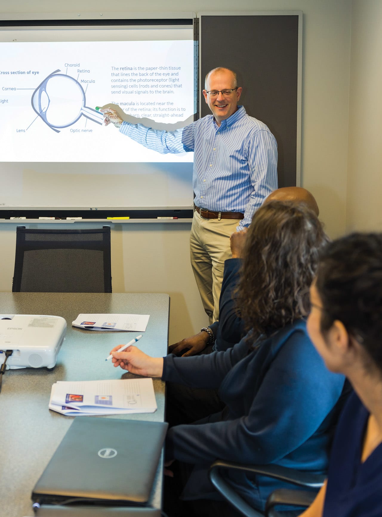 Brian Connolly, MD, reviews ocular anatomy during an in service for staff on vitrectomy surgery.