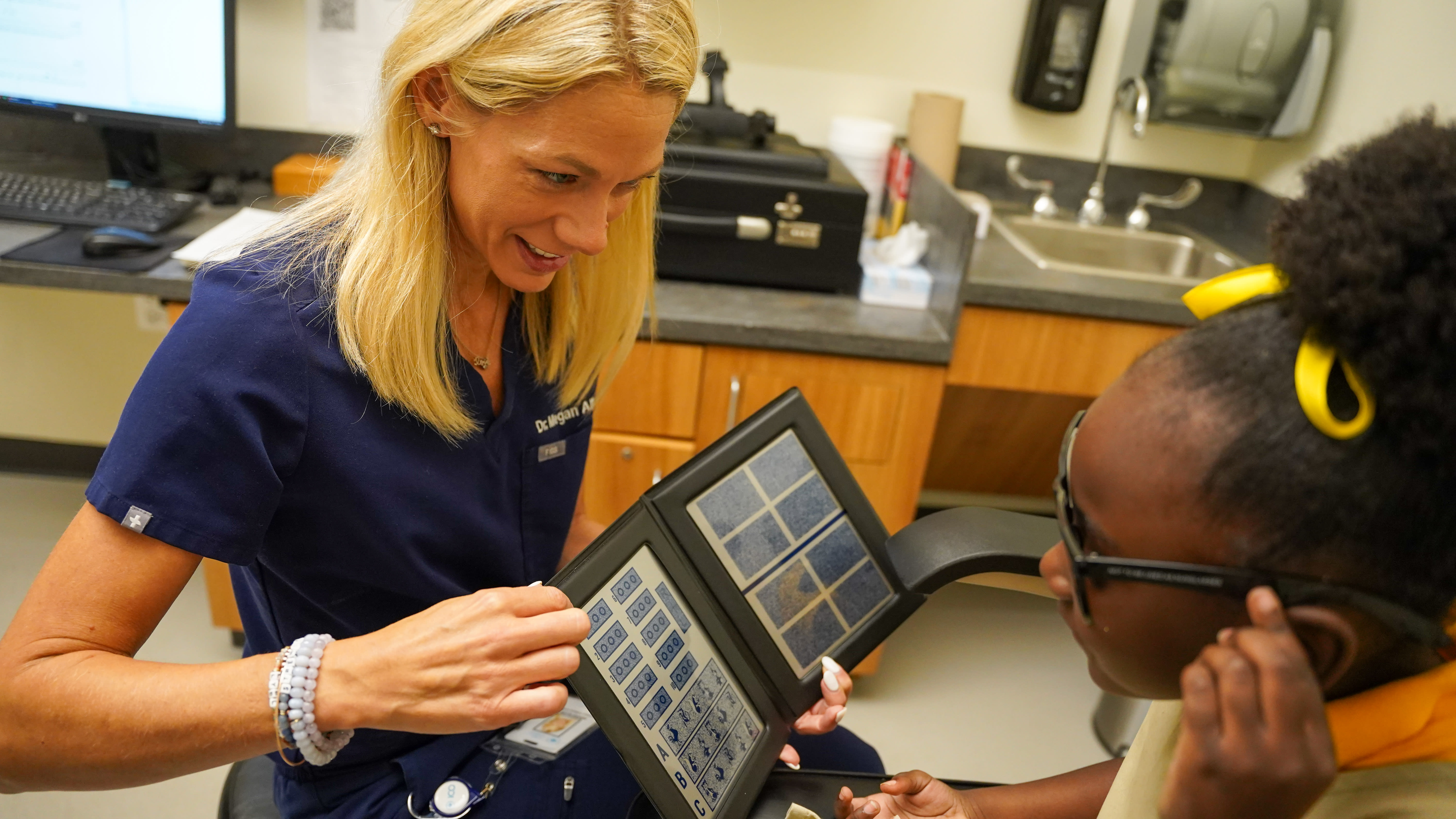 Dr. Allen examines a young patient. (Photo courtesy: Dr. Allen)