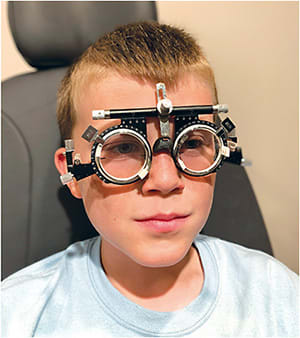 A patient uses a trial frame prism in Dr. Richard’s office. Image courtesy of Dr. Richard.