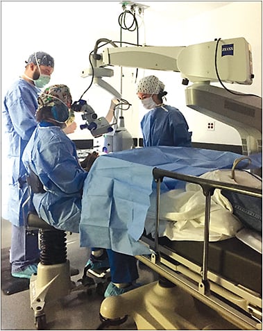 Dr. Dan Langley performs cataract surgery while Dr. Lindsey Bull, standing opposite of the doctor looking in the microscope, observes.Courtesy of staff at South TUlsa Surgical Center