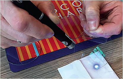 Opticians at Eyesite use lenses and a penlight to demonstrate blue light technology to patients.