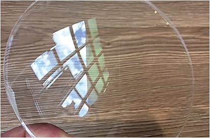 This lens demonstrates AR coating. At left, note the reflection of light from the window, whereas the right side, which is coated, does not show the reflection. 
Photos courtesy of Eyesite