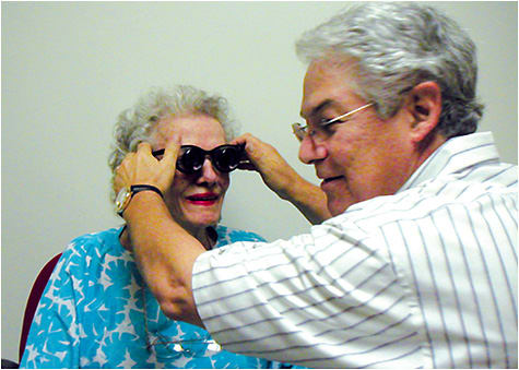 Dr. Shuldiner assists a patient with her low vision aid.
Photos courtesy of Dr. Richard Shuldiner