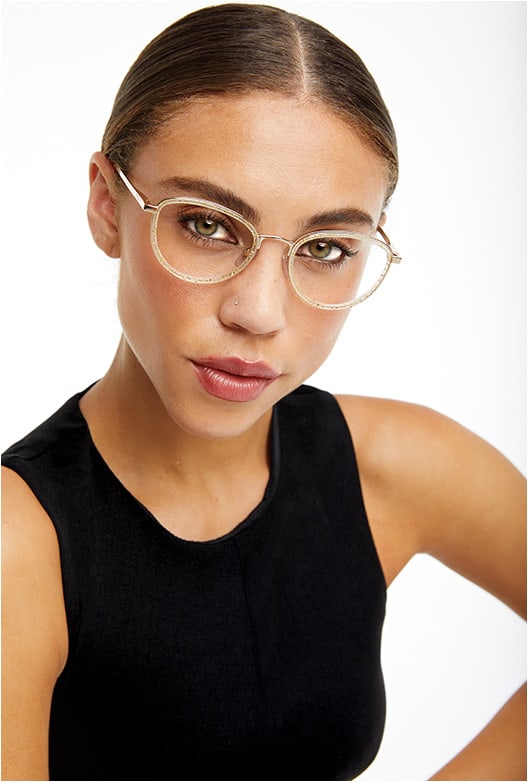 IT’S A BLING THING.
The Furla VFU 254 from De Rigo REM brings on the bling in a gold wire rim and acetate round silhouette embedded with golden glitter.