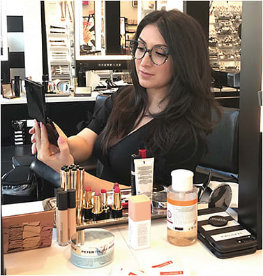 The author trying new makeup looks with her specs