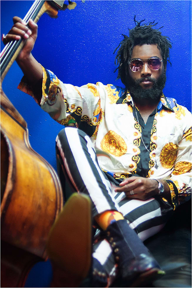 DOWNBEAT
On Julliard-trained, sought-after bassist Russell Hall: MCM style MCM129S from Marchon Eyewear shines in gold metal with a deep modified aviator silhouette with rose-colored lenses.
Hailing from Kingston, Jamaica, Hall has performed and recorded with artists such as Branford and Wynton Marsalis, Jon Batiste, and Stay Human. He currently fronts his own group, The Enigmatics, which celebrates the legacy of legends like Thelonius Monk and Dizzy Gillespie.
russellhallbass.com