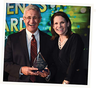 Bob Colucci, president, Independent Distribution Division, receives the Essilor Vision Foundation President’s Award from its president, Kim Schuy