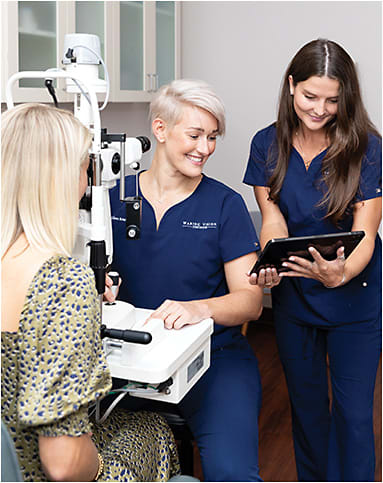 Ms. VanDeWater (right) assists Dr. Boiwka, who leads the Health, Wellness &amp; Dry Eye Clinic at the Waring Vision Institute.
